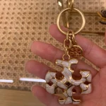 Tory Burch Gold & White Enamel Keychain – Signature Logo Charm - Image 2